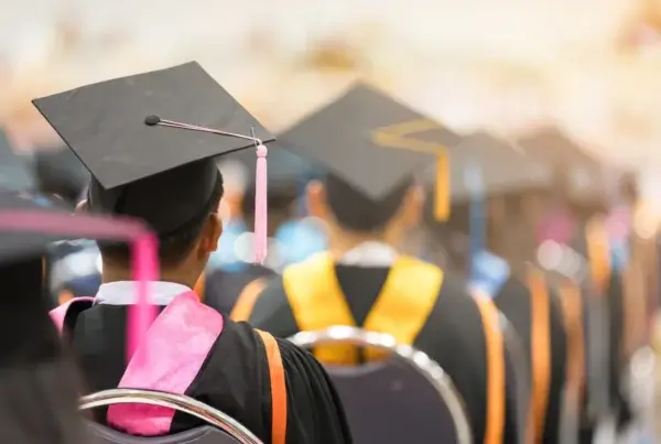 A joyful scene of graduates in caps and gowns at a Malaysian graduation ceremony, capturing their special moment of success.