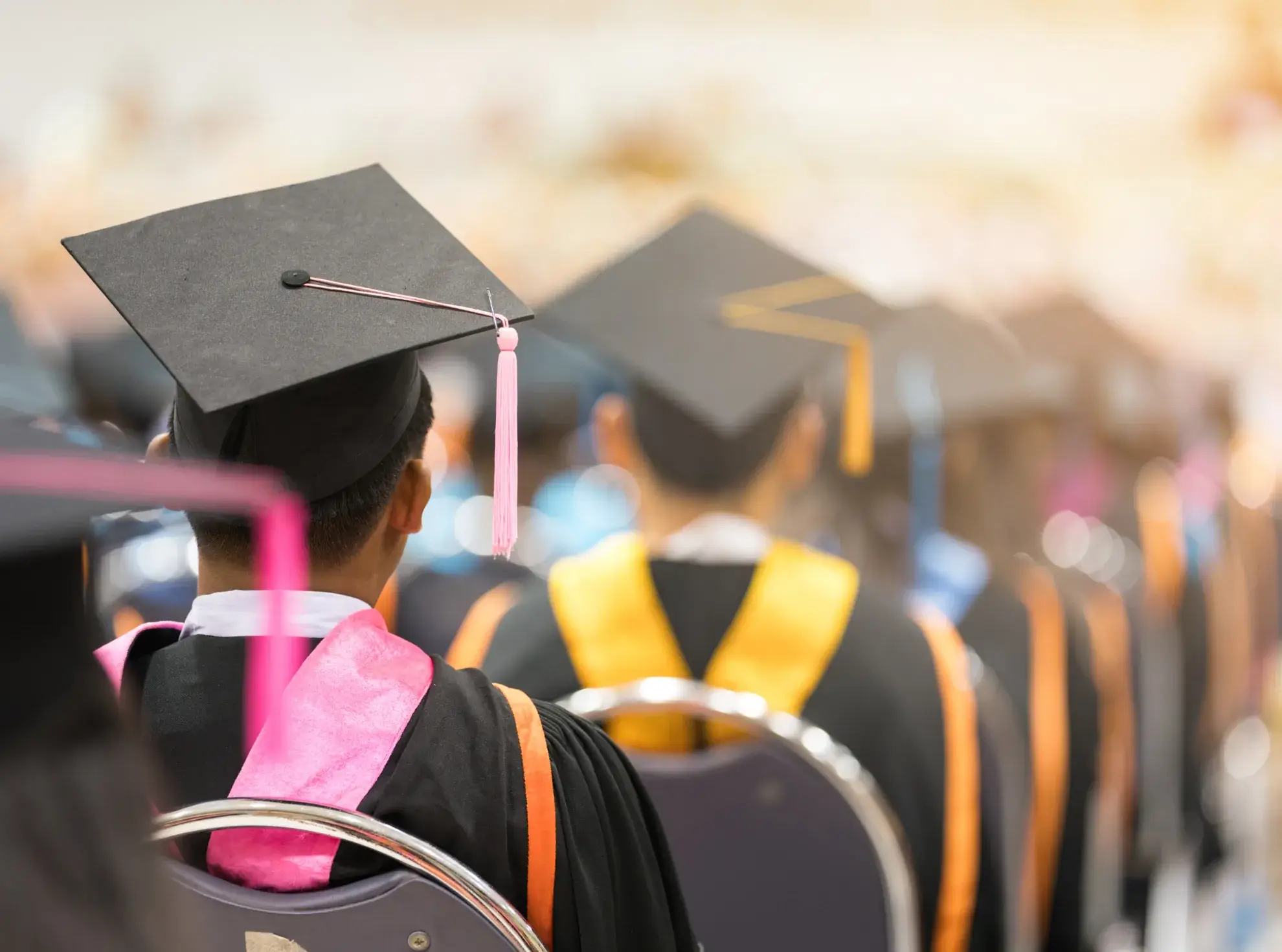 A joyful scene of graduates in caps and gowns at a Malaysian graduation ceremony, capturing their special moment of success.